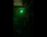 Small green light moves between fingers guy 