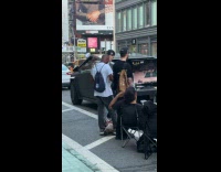 Men playing 2k behind cybertruck on street