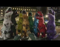 Group of people dressed as colorful dinosaurs