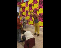 Girl yellow pants giraffe pink wall 