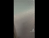 Woman shows person made of hair on her shower