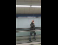 Guy dancing on flat escalator dance backwards