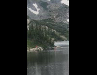 Red shirt guy photographs girl in water