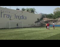 Guy kicks soccer ball at goal frame and misses