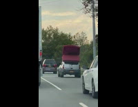White car red folded mattress on roof 