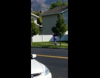 Man and woman films couch moved on the sidewalk