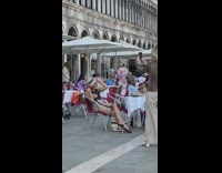 Woman in a dress and hat with a tobacco pipe 