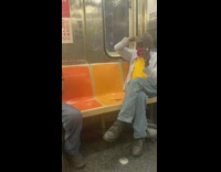 Man combs his beard on train 