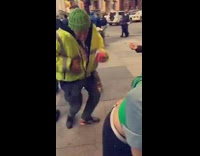 Safety Vest Man Dances Next to Passed Out Girl Being Held Up By Friends