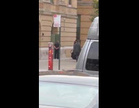 Men in suit runs inside gate entrance 