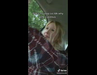 Girl in car crying with guy in blue hat