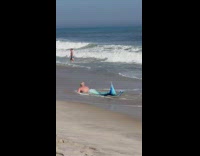 Person lays on shore in a mermaid tail