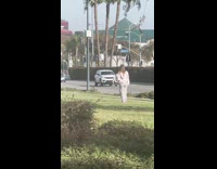 Woman sweater dances side of the street