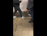 Guy at train station wears plastic over his shoes