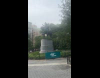 Man sitting on top of George Washington statue