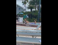 Yellow bikini girl community pool palm trees