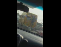 Man on the back of the van on the road