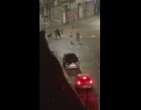 Two guys dance middle street night car