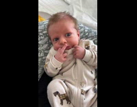 Newborn baby lifts middle finger