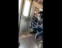 Man holds his Husky dog inside backpack, dog sticks out head and tongue