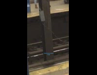 guy orange hat charging laptop roof of station