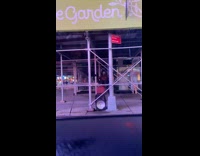 Guy sits scaffolding bar leg lift exercises 