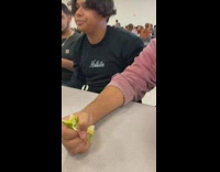 Guy grabs fistful of salad 