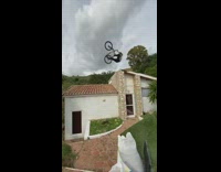 Guy does backflip off house on bike