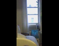 Guy swings legs over apartment rooftop 