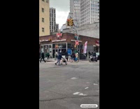 Collab WINY - Man rides bike balance tire on head near buffalo boss store