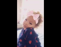 Little girl is feeling herself with pink hair bow heart filter, mom laughs at her