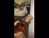 Guy with bottle of Captain Morgan with security cover on 