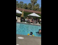 Woman bikini kneel over pool bed kid