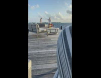 Girl white bikini on pier ocean bench