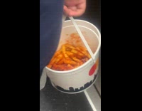 Collab WINY - Man carry bucket of fries filled with ketchup