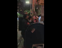 Guy sings white megaphone drums restaurant sidewalk 