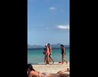 Woman in bikini dances for beach video