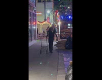 Kitten sits on guys back while he walks 