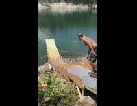 Guy rides skateboard wood ramp fail lake 