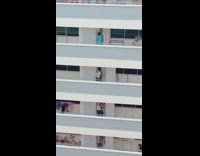 Group of workers lined up on each floor of building