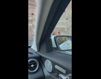 People along large red brick wall