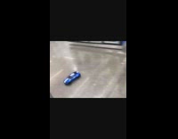 Guys drive remote controlled car in Walmart