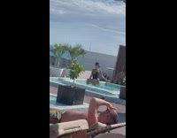 Woman black onesie show hand splash pool water