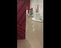 Woman lifts another woman to pose like the statue beside them