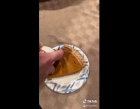 Man puts whipped cream  on pie