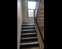 Rain water flows from rooftop to stairs