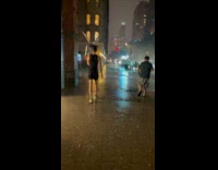 Guy uses chair as umbrella in rain