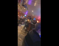 Blue suit jumps on man at bar who hits head