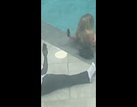 White shirt guy sits by pool girl 