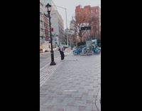 Guy hits boxes on ground with club